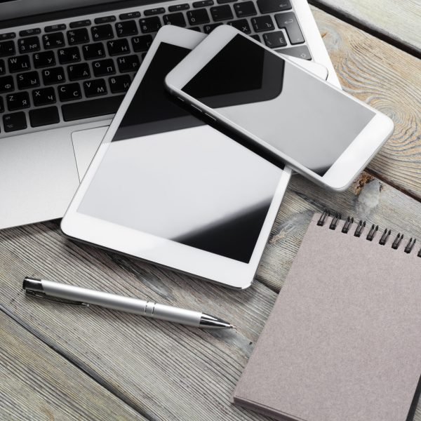 Open laptop with digital tablet and smartphone close up